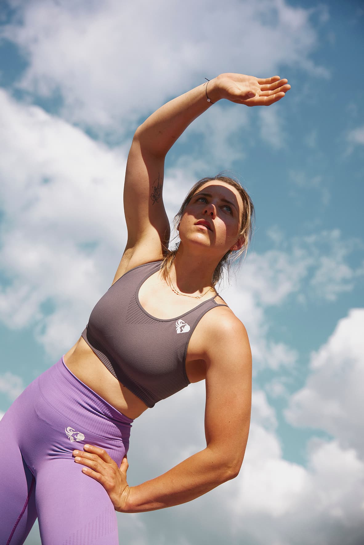 Girl doing gymnastics in an urban outdoor landscape, at the Landessportzentrum and against a summer sky